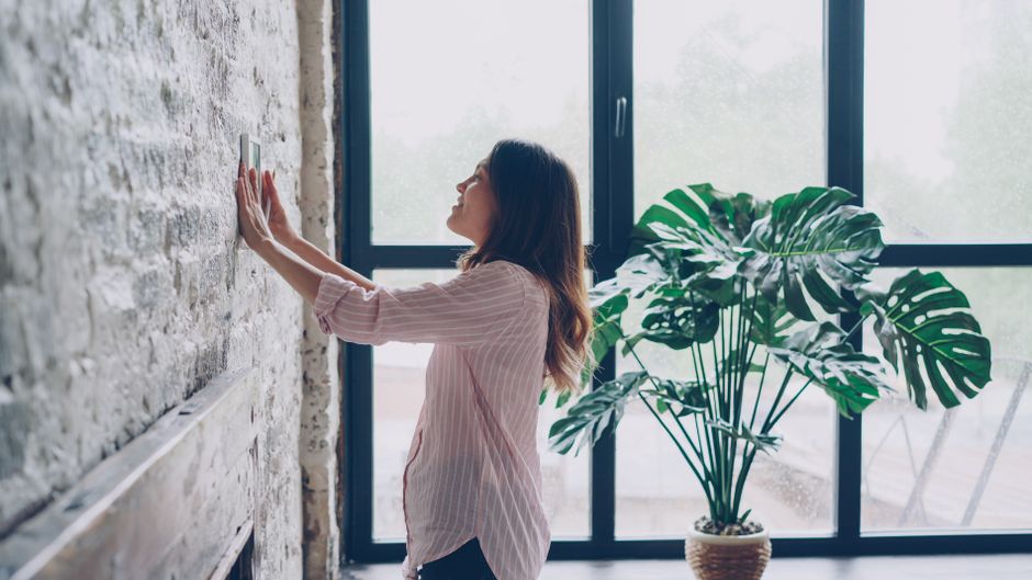 A smart thermostat mounted on a wall