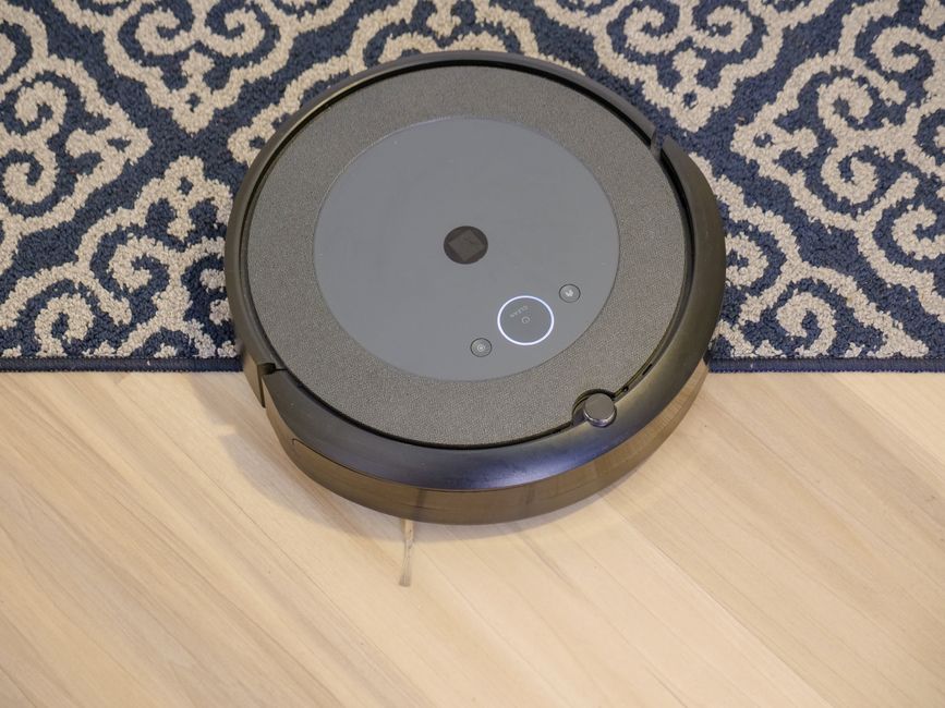 A robot vacuum cleaning a carpeted floor