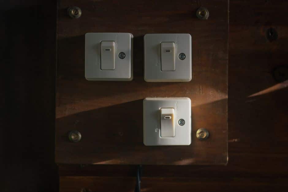 A modern living room with a smart light switch on the wall