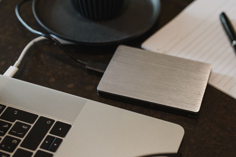 A hard drive and cloud backup icon representing data backup