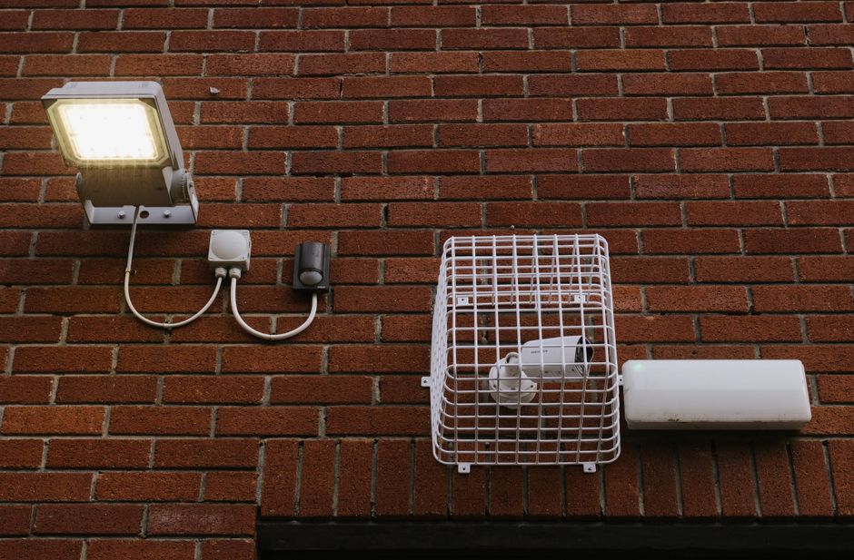 A person leaving home with a smartphone showing location tracking